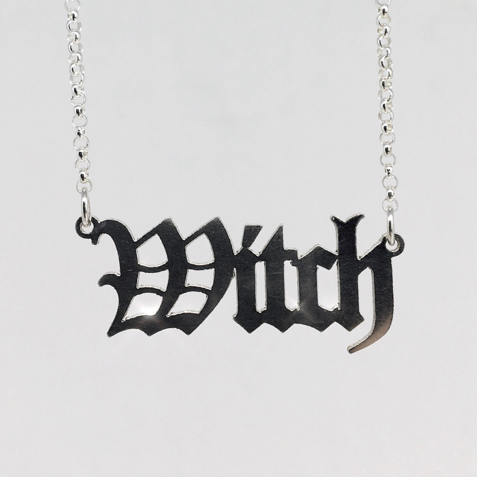 sterling silver witch nameplate necklace in gothic blackletter font.