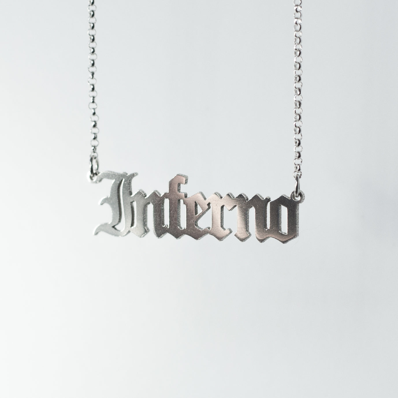 Sterling silver Inferno Necklace in gothic blackletter font.