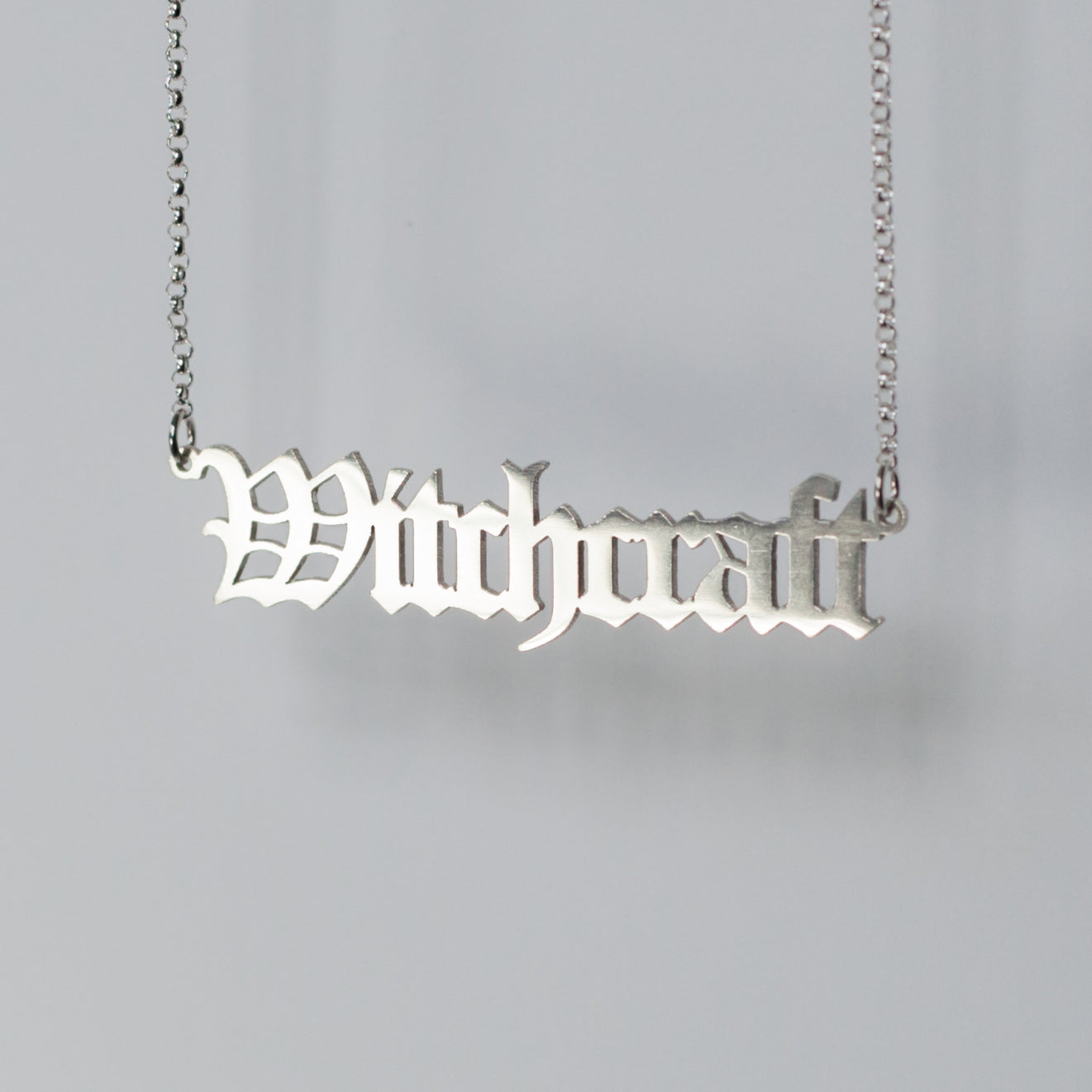 Witchcraft Necklace in gothic blackletter font in sterling silver