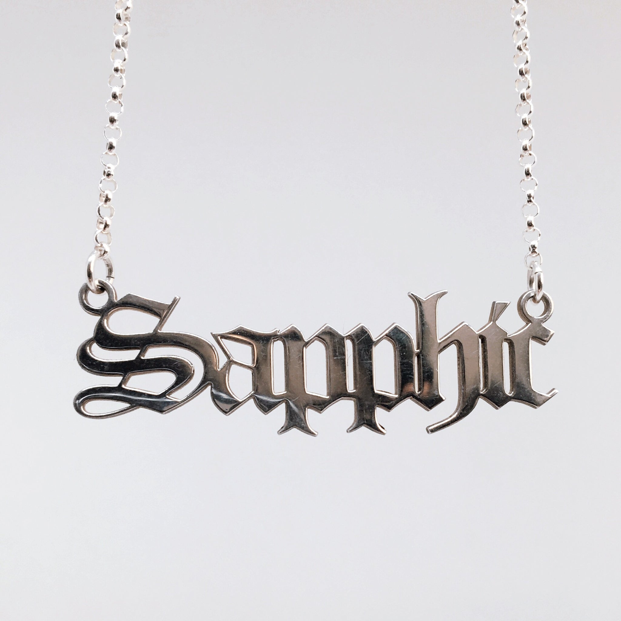 Sterling silver Sapphic nameplate necklace in gothic blackletter font.
